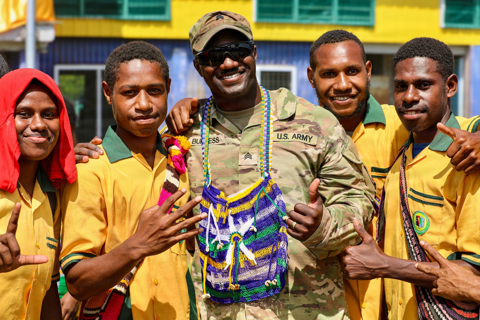 Sgt. David Burgess, assigned to the 844th Engineer Battalion, poses with students from Igam Barracks Primary School during the closing ceremony for the ENCAP and health engagement at Igam Barracks in Lae, Papua New Guinea, July 22, 2026.