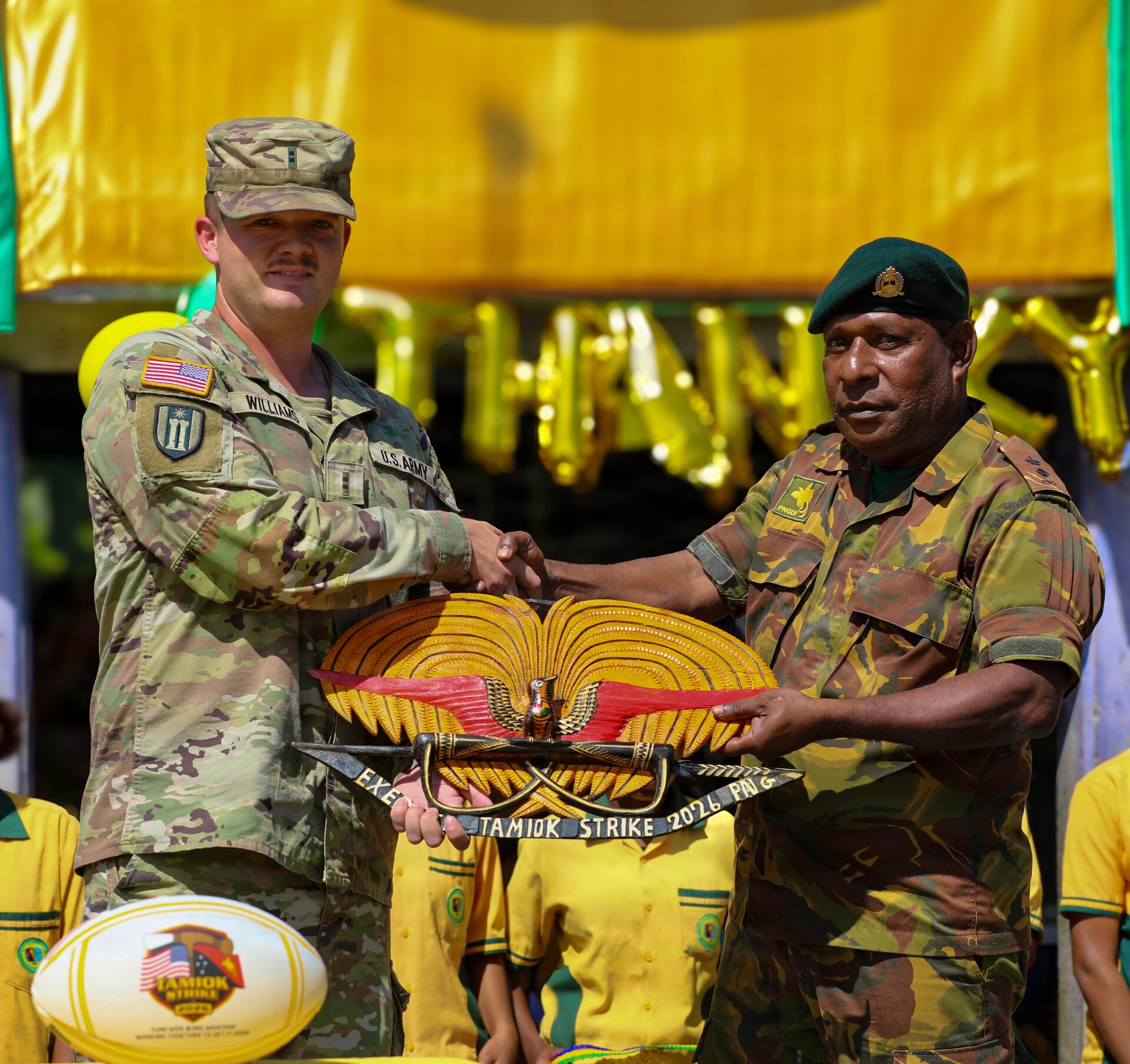 Chief Warrant Officer 2 Austin Williams, officer in charge of the Engineer Civic Action Project (ENCAP), assigned to the 844th Engineer Battalion, receives a commemorative gift from a Papua New Guinea Defence Force representative during the closing ceremony for the ENCAP and health engagement at Igam Barracks in Lae, Papua New Guinea, July 22, 2026.