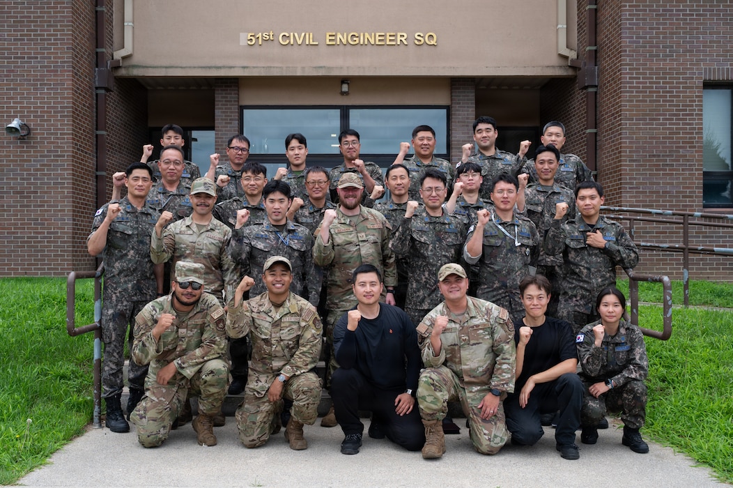 Group photo in front of 51st Civil Engineer Squadron building
