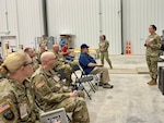 Air Force Brig. Gen. Heather Blackwell (right), 16th Air Force’s Joint Force Headquarters Deputy Commander for Cyber, engages with leadership at the Joint Electric Power Range, Fort Carson, Colo., June 18, 2026. Blackwell, U.S. Cyber Command leadership, and federal government leaders observed joint military and civilian student operators at the culmination of a two-week Joint Electric Power Range training event, using an accurate, live-grid-connected environment. (U.S. Air Force photo by Dawn Crook)