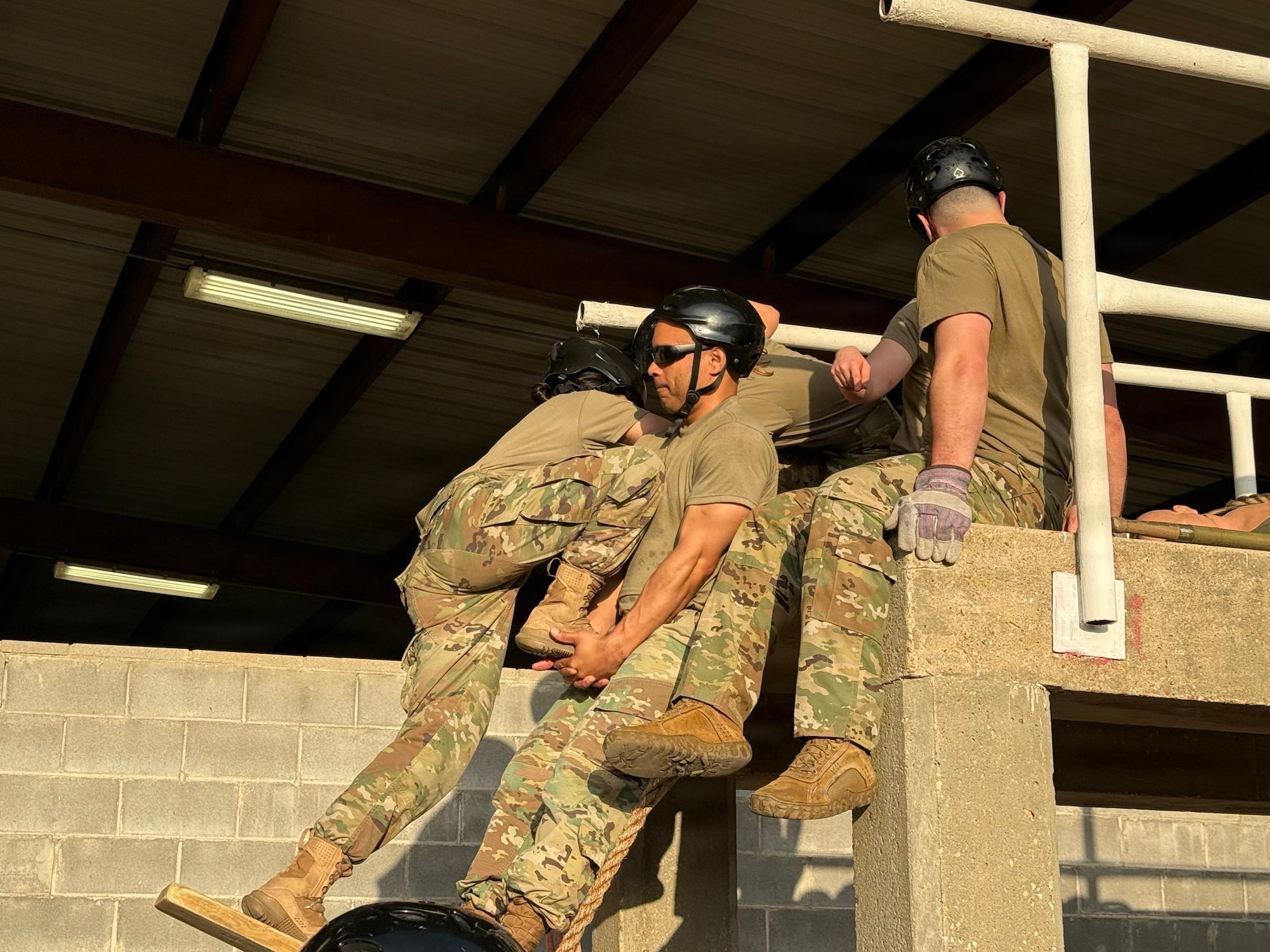 Squadron Officer School students work together to navigate an obstacle during the Leadership Reaction Course at Maxwell Air Force Base, Alabama.
