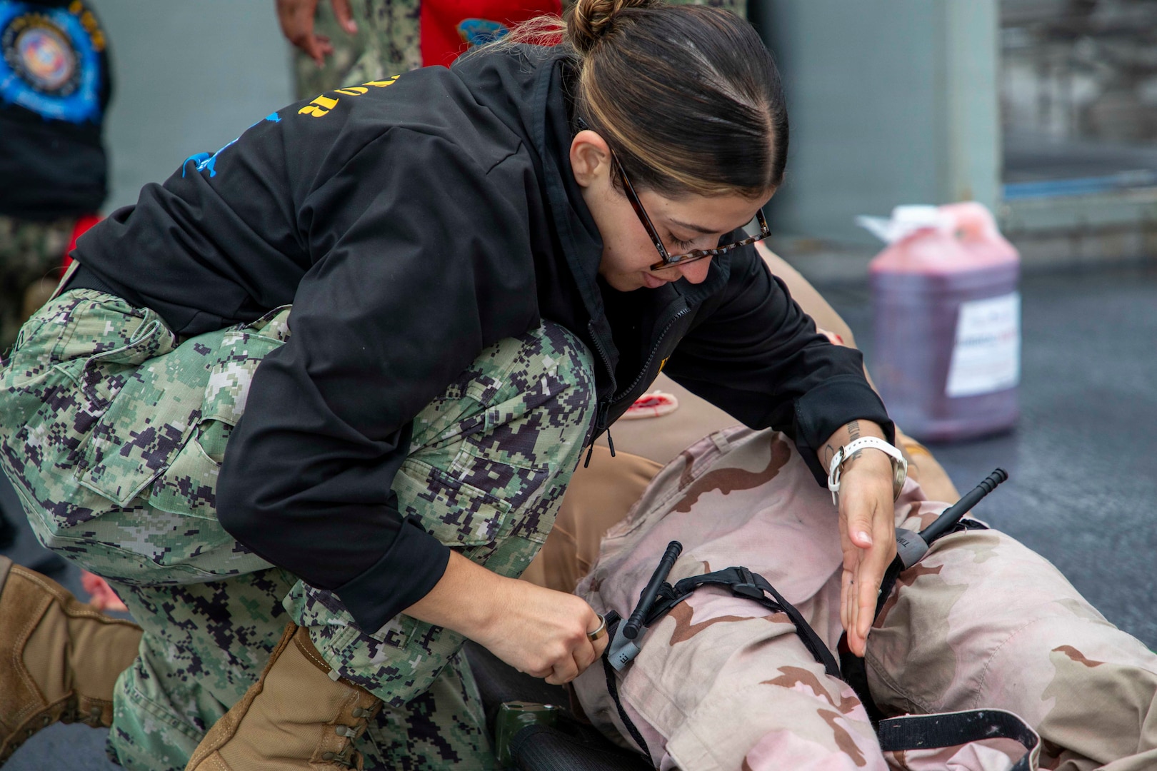 Logistics Specialist Petty Officer 2nd Class Sandra Ahmad, assigned to Naval Expeditionary Medicine Warfighter Development Center, applies a tourniquet to a medical dummy during an Operational Readiness Evaluation (ORE) of an Expeditionary Medical Unit (EMU) aboard the expeditionary fast transport ship USNS Point Loma (T-EPF 15), July 25, 2026. The event marked the Navy’s first ORE conducted for an EMU, and the first afloat ORE for the Navy’s expeditionary medical capability, a critical step in validating deployable medical capabilities in support of maritime operations, distributed maritime operations, and warfighter readiness. (U.S. Navy photo by Mass Communication Specialist 1st Class Nathan T. Beard)