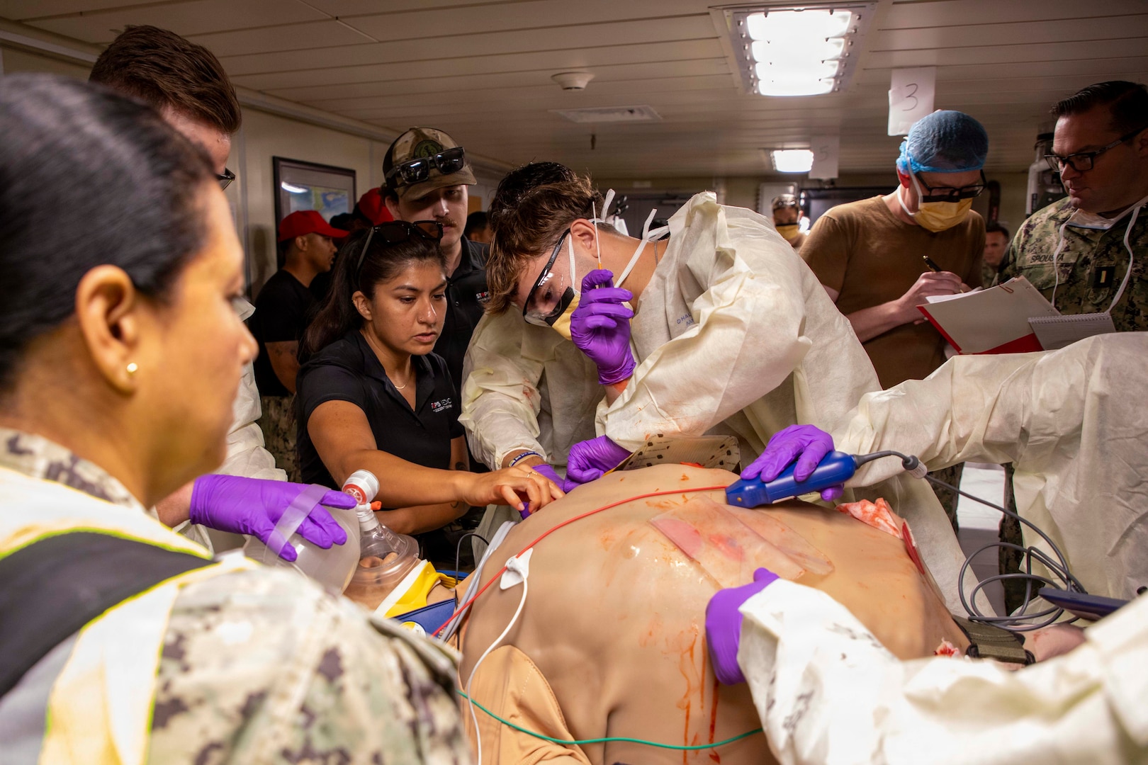 Sailors assigned to the Expeditionary Medical Unit (EMU-2) perform needle thoracostomy on a medical dummy during an Operational Readiness Evaluation (ORE) aboard the expeditionary fast transport ship USNS Point Loma (T-EPF 15), July 25, 2026. The event marked the Navy’s first ORE conducted for an EMU, and the first afloat ORE for the Navy’s expeditionary medical capability, a critical step in validating deployable medical capabilities in support of maritime operations, distributed maritime operations, and warfighter readiness. (U.S. Navy photo by Mass Communication Specialist 1st Class Nathan T. Beard)