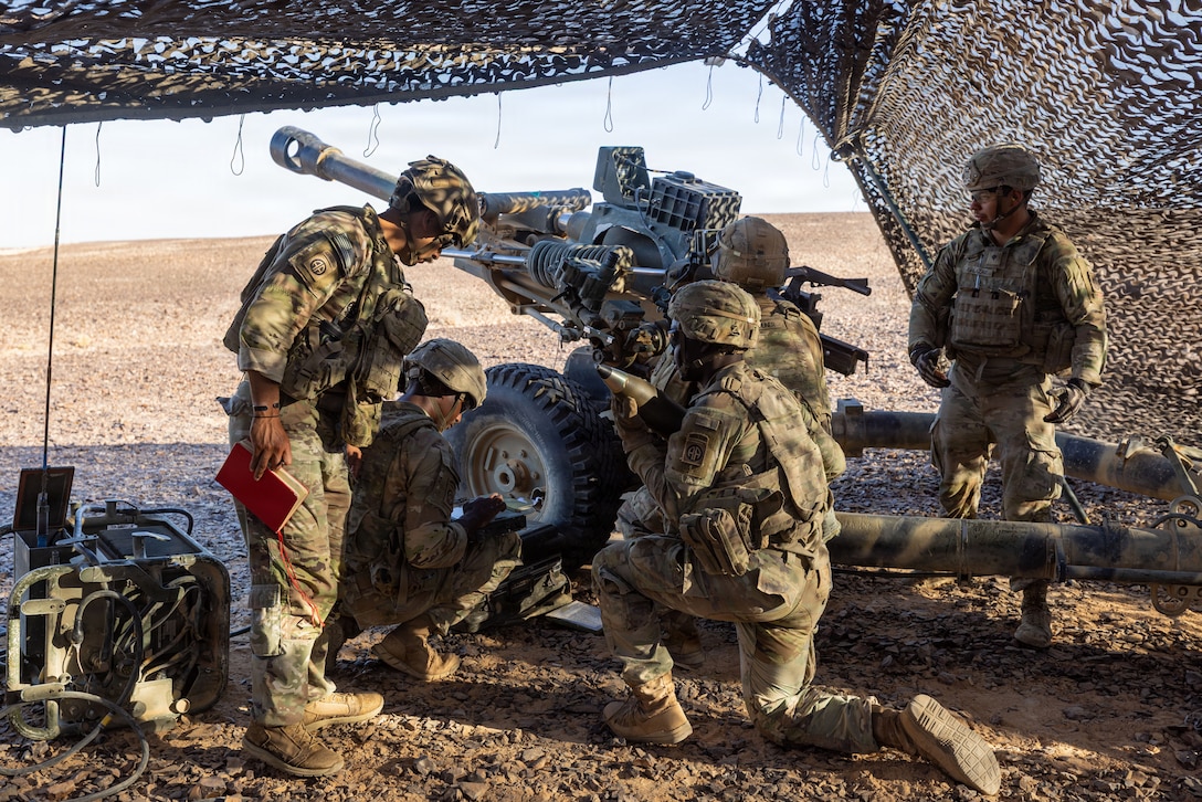 U.S. Army paratroopers prepare an M119 howitzer for a fire mission during a field artillery live-fire exercise in the Middle East. The exercise validated capabilities, demonstrating the synchronized lethality required to systematically target and degrade adversaries in multi-domain combat operations. (U.S. Army photo)