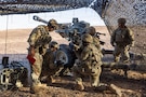 U.S. Army paratroopers prepare an M119 howitzer for a fire mission during a field artillery live-fire exercise in the Middle East. The exercise validated capabilities, demonstrating the synchronized lethality required to systematically target and degrade adversaries in multi-domain combat operations. (U.S. Army photo)