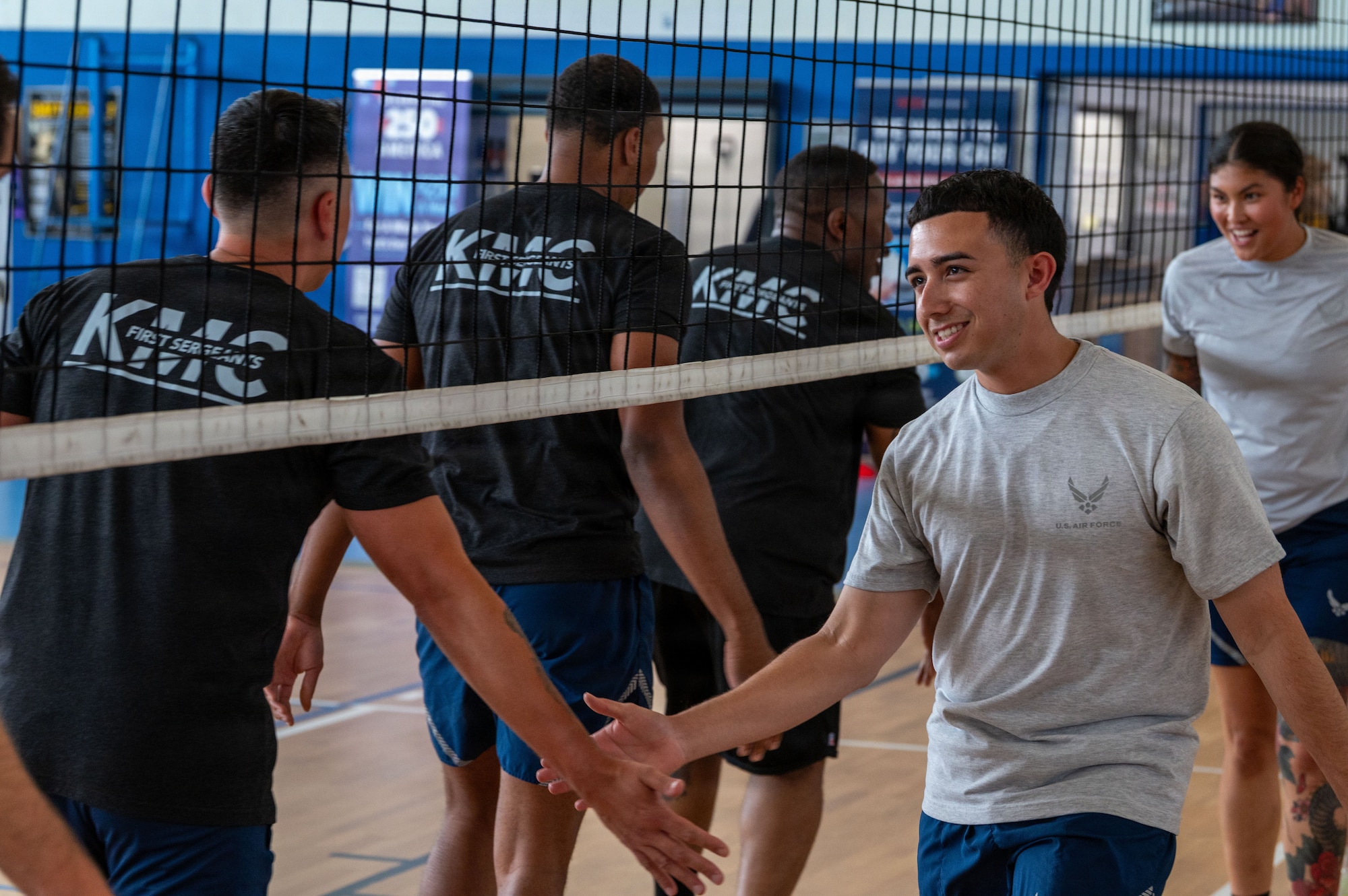 Kaiserslautern Military Community first sergeants and Airman Leadership School students high-five following a volleyball match.
