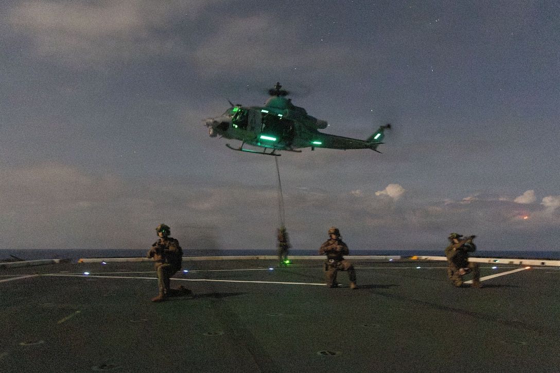 U.S. Marines, with Maritime Raid Force, Littoral Combat Force-24, post security after fast-roping off a U.S. Marine Corps UH-1Y Venom assigned, to Marine Medium Tiltrotor Squadron (VMM) 365 (Reinforced), LCF-24, during lowlight fast-roping drills while underway in the Caribbean Sea, July 23, 2026. U.S. military forces are deployed to the U.S. Southern Command area of responsibility in support of Operation SOUTHERN SPEAR, Department of War-directed operations, and the president’s priorities to disrupt illicit drug trafficking, deter malign actors and protect the homeland through continuous presence. (U.S. Marine Corps photo)