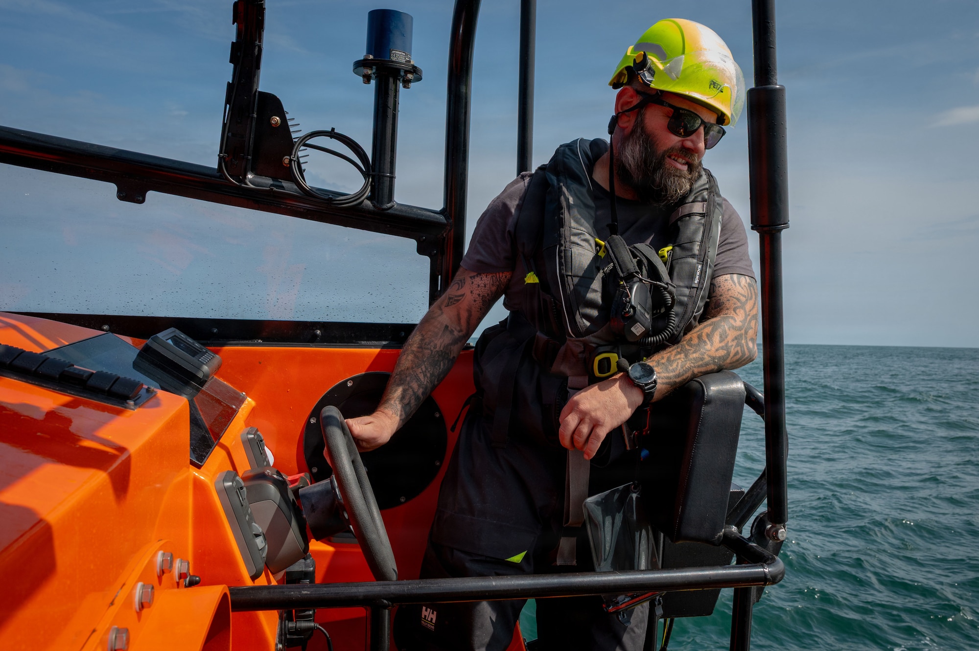 Richard Thurlow, Caister Lifeboat coxswain, steers a lifeboat during a joint survival, evasion, resistance, and escape training with U.S. Airmen at Caister-on-Sea, England, July 23, 2026.