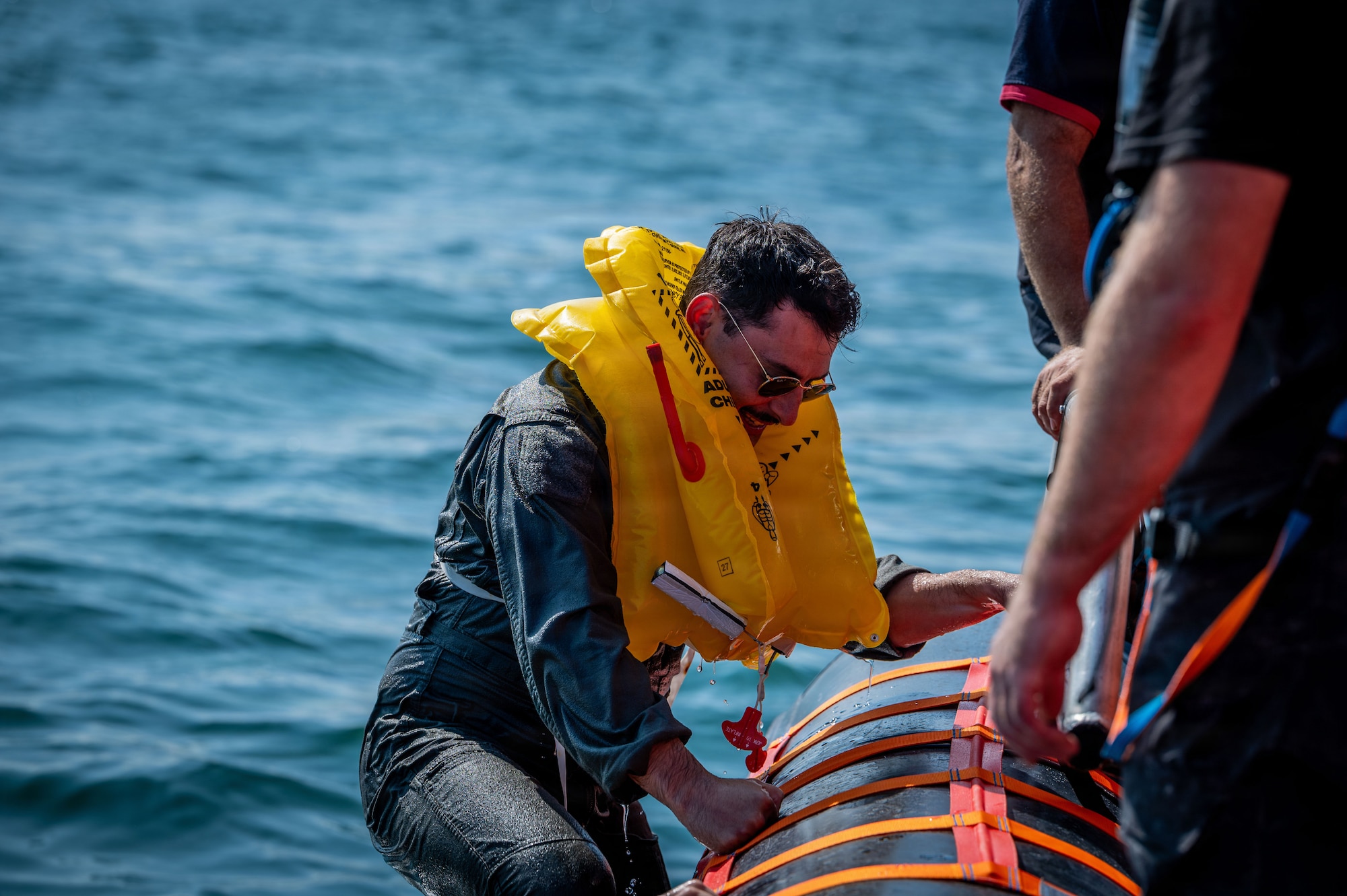 U.S. Air Force 1st Lt. Abraham Kinghorn, 351st Air Refueling Squadron mission planner, climbs into a Caister lifeboat during a joint survival, evasion, resistance, and escape training at Caister-on-Sea, England, July 23, 2026.