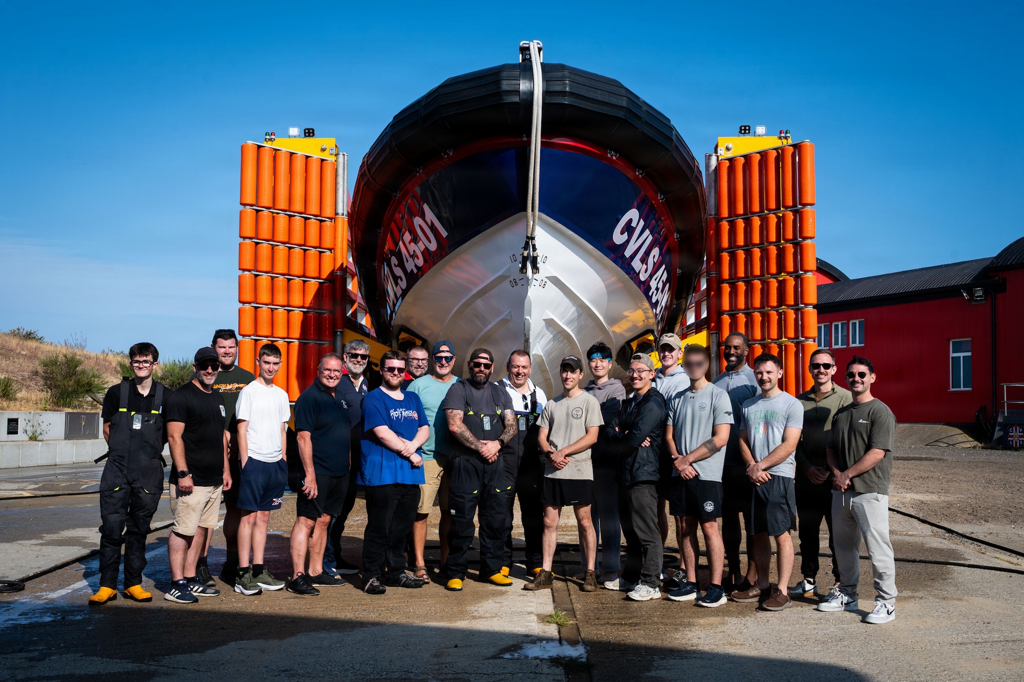 U.S. Airmen and volunteer Caister Lifeboat Volunteer Service crew members pose for a group photo after a joint survival, evasion, resistance, and escape training at Caister-on-Sea, England, July 23, 2026.