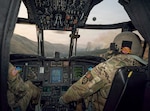U.S. Army Chief Warrant Officer 5 Donald Ford, right, and Capt. Richard Duval pilot a CH-47 Chinook helicopter toward the Hagen Fire in Umatilla County, Oregon, July 29, 2026, during water bucket operations in support of Oregon's wildfire response. Photo by Maj. Wayne Clyne.