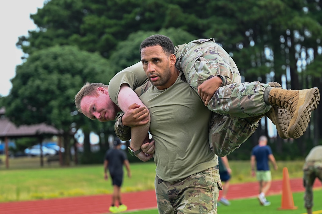 A guy is carrying another guy on his shoulders