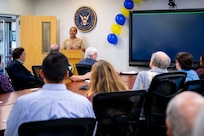 Capt. Randy Cruz, U.S. Naval Research Laboratory (NRL) Commanding Officer, addresses NRL personnel, family and alumni at the commemoration of the 70th anniversary of the Blossom Point Tracking Facility in Welcome, Md., July 30, 2026. The facility provides round-the-clock operations utilizing full automation and enables "lights-out" satellite contacts. (U.S. Navy Photo by Sarah Peterson)
