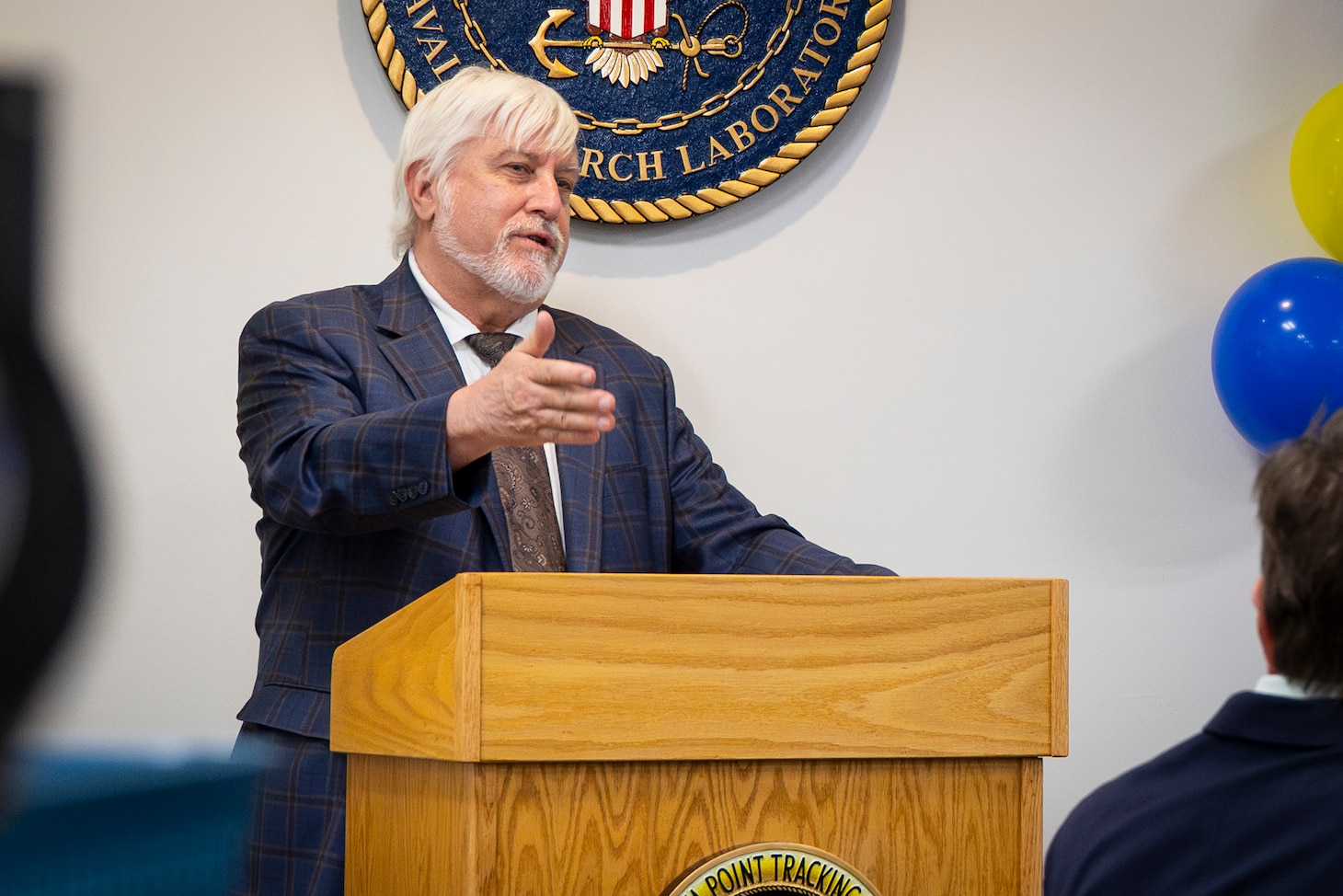 Dr. Bruce Danly, U.S. Naval Research Laboratory (NRL) Director of Research, addresses NRL personnel, family and alumni at the commemoration of the 70th anniversary of the Blossom Point Tracking Facility in Welcome, Md., July 30, 2026. The facility provides round-the-clock operations utilizing full automation and enables "lights-out" satellite contacts. (U.S. Navy Photo by Sarah Peterson)