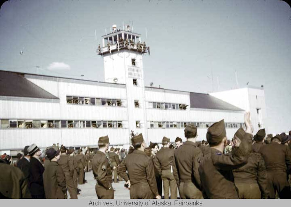 Soldiers and civilians gather on the flight line during an airshow at Ladd Field, Alaska, circa 1946–1948.