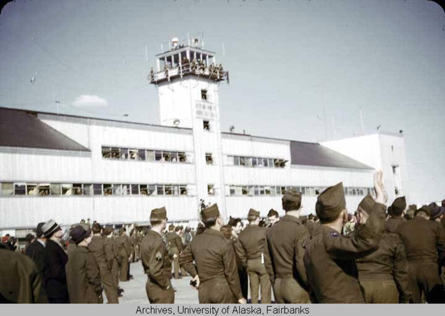 Soldiers and civilians gather on the flight line during an airshow at Ladd Field, Alaska, circa 1946–1948.