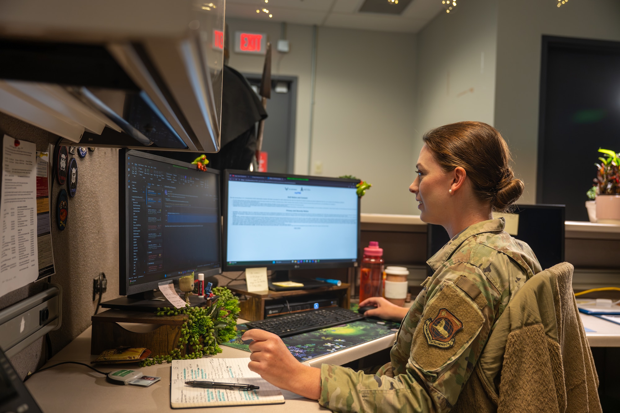 Staff Sgt. Sara Hallstein, Intelligence Support Squadron noncommissioned officer in charge, works at her desk at the National Air and Space Intelligence Center, Wright-Patterson Air Force Base, Ohio, June 25, 2026. In addition to her duties as a leader at NASIC, Hallstein champions the role of art and creativity as essential tools for building resilience and morale among Airmen. (U.S. Air Force photo by Staff Sgt. Kristof J. Rixmann)