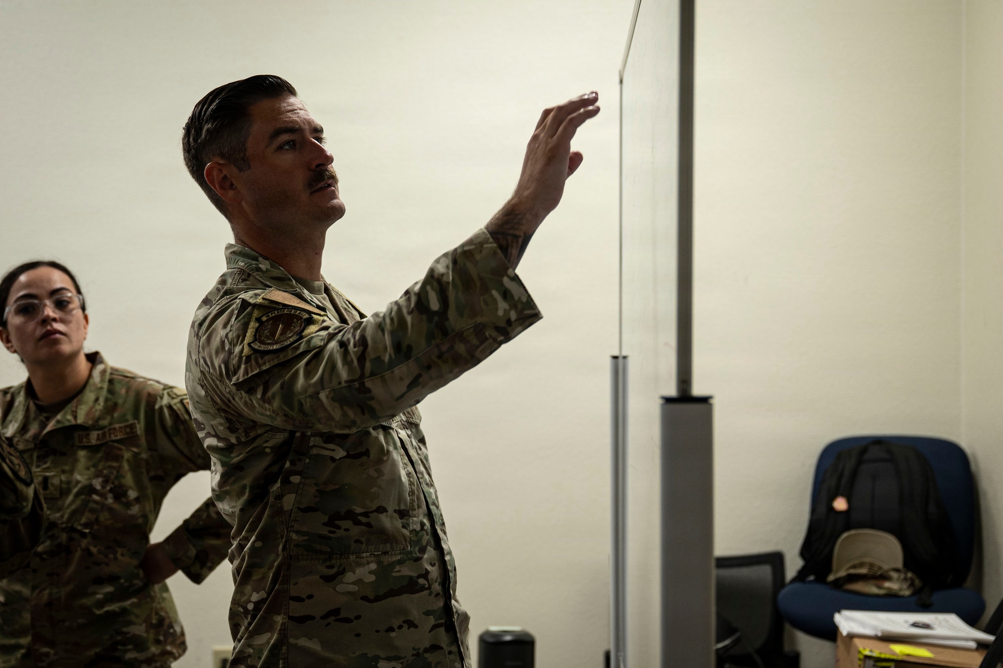 U.S. Air Force Airmen assigned to the 355th Wing work together during the Exercise Kingfish Ace portion of the Air Expeditionary Wing Command and Control course at Davis-Monthan Air Force Base, Arizona, July 22, 2026. Building integrated planning and coordination skills through AEWC2C strengthened readiness for future expeditionary operations. (U.S. Air Force photo by Airman 1st Class Samantha Melecio)