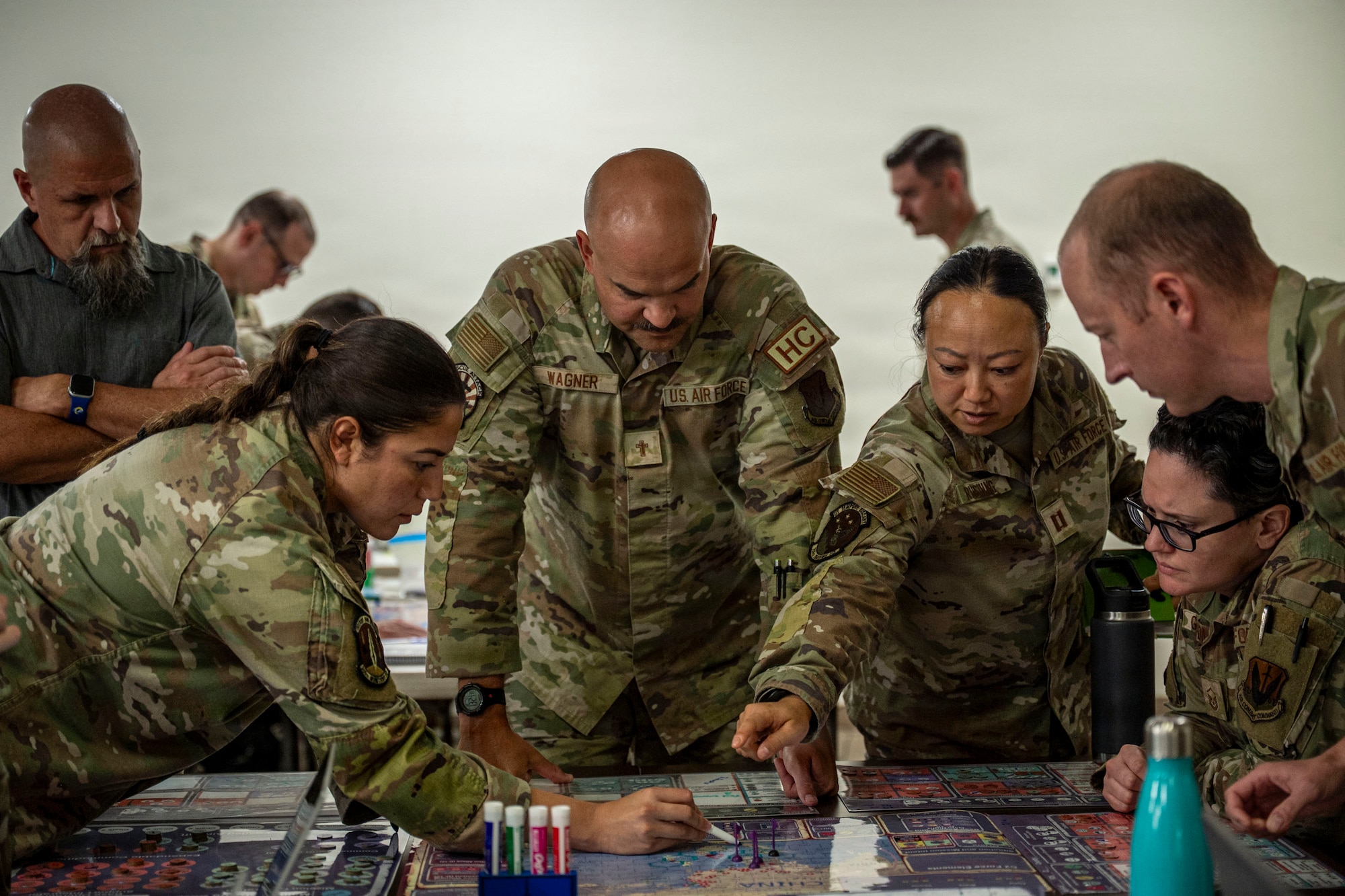U.S. Air Force Airmen assigned to the 355th Wing work together during the Exercise Kingfish Ace portion of the Air Expeditionary Wing Command and Control course at Davis-Monthan Air Force Base, Arizona, July 22, 2026. Building integrated planning and coordination skills through AEWC2C strengthened readiness for future expeditionary operations. (U.S. Air Force photo by Airman 1st Class Samantha Melecio)