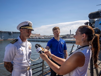 NORFOLK, Va. (July 31, 2026) — U.S. Navy Cmdr. Taylor Auclair, commanding officer of the Arleigh Burke-class guided-missile destroyer USS Truxtun (DDG 103) speaks with local media on Norfolk, July 31, 2026. The ship's return concludes a six-month deployment across multiple geographic theaters, including the U.S. 4th, 5th and 6th Fleet areas of operations. (U.S. Navy photo by Mass Communication Specialist 2nd Class Justin McTaggart)