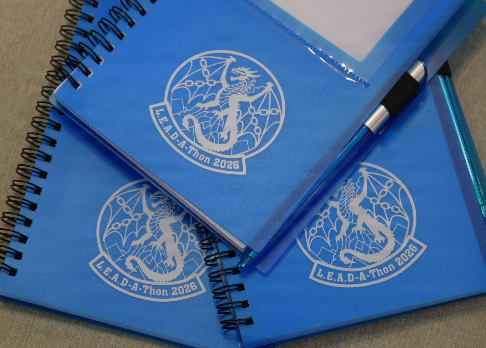 Blue event notebooks are on display.