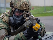 A U.S. Air Force Airman assigned to the 8th Fighter Wing takes a defensive position during an opposing-force training scenario for Beverly Sentinel 26-4 at Kunsan Air Base, South Korea, July 22, 2026. The realistic training required personnel to adapt to complex challenges and strengthened their ability to execute the mission under high-stress conditions. (U.S. Air Force photo by Senior Airman Tabatha Chapman)