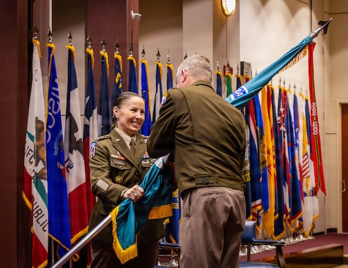 Maj. Gen. Lori Robinson relinquishes the U.S. Army Aviation and Missile Command guidon to Lt. Gen. Chris Mohan, commanding general of U.S. Army Materiel Command, during a relinquishment of command ceremony at Redstone Arsenal, Ala., July 31, 2026. Robinson relinquished command of AMCOM before retiring after 32 years of Army service.