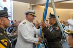 In his last act as outgoing Western Sector commander, Navy Capt. Chris Carmichael passes the Western Sector colors to Col. Frankie Cochiaosue, USMEPCOM commander. USMEPCOM held the Western Sector Change of Command on July 31, in North Chicago.