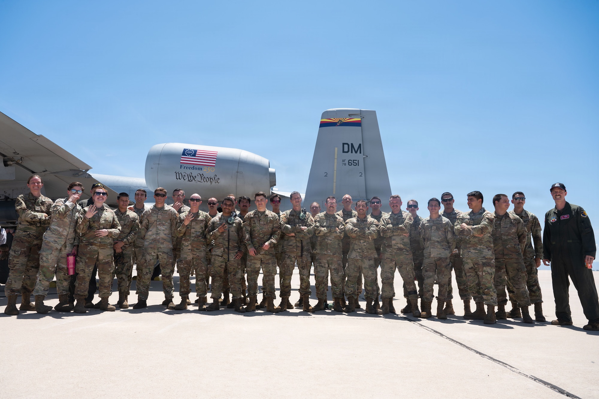 The 357th Fighter Generation Squadron poses for one final group photo in front of an A-10C Thunderbolt II.