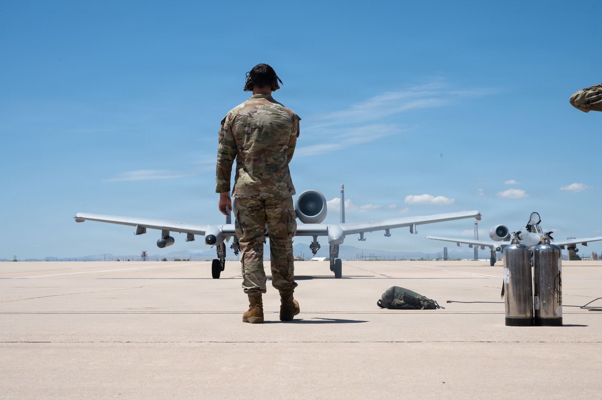 A U.S. Airman marshals an A-10C Thunderbolt II aircraft on the flightline following the completion of its final flight at Davis-Monthan Air Force Base, Arizona, July 29, 2026. The A-10 divestment honors the aircraft’s incredible legacy while preparing Airmen for the demands of future readiness. (U.S. Air Force photo by Airman Najzee Kuzu)