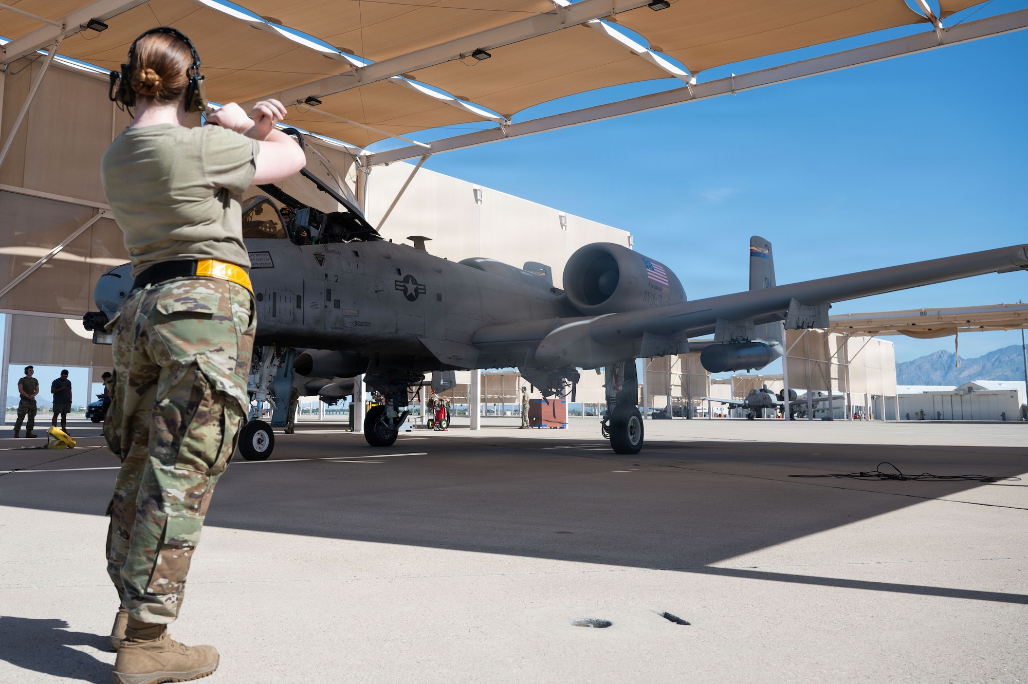 U.S. Air Force 2nd Lt. Madison Soboslai, 337th Air Control Squadron undergraduate battle manager, marshals an A-10C Thunderbolt II aircraft before its final flight at Davis-Monthan Air Force Base, Arizona, July 29, 2026. The A-10’s close air support mission has been a constant for those at Davis-Monthan and the surrounding community for nearly five decades. (U.S. Air Force photo by Airman Najzee Kuzu)