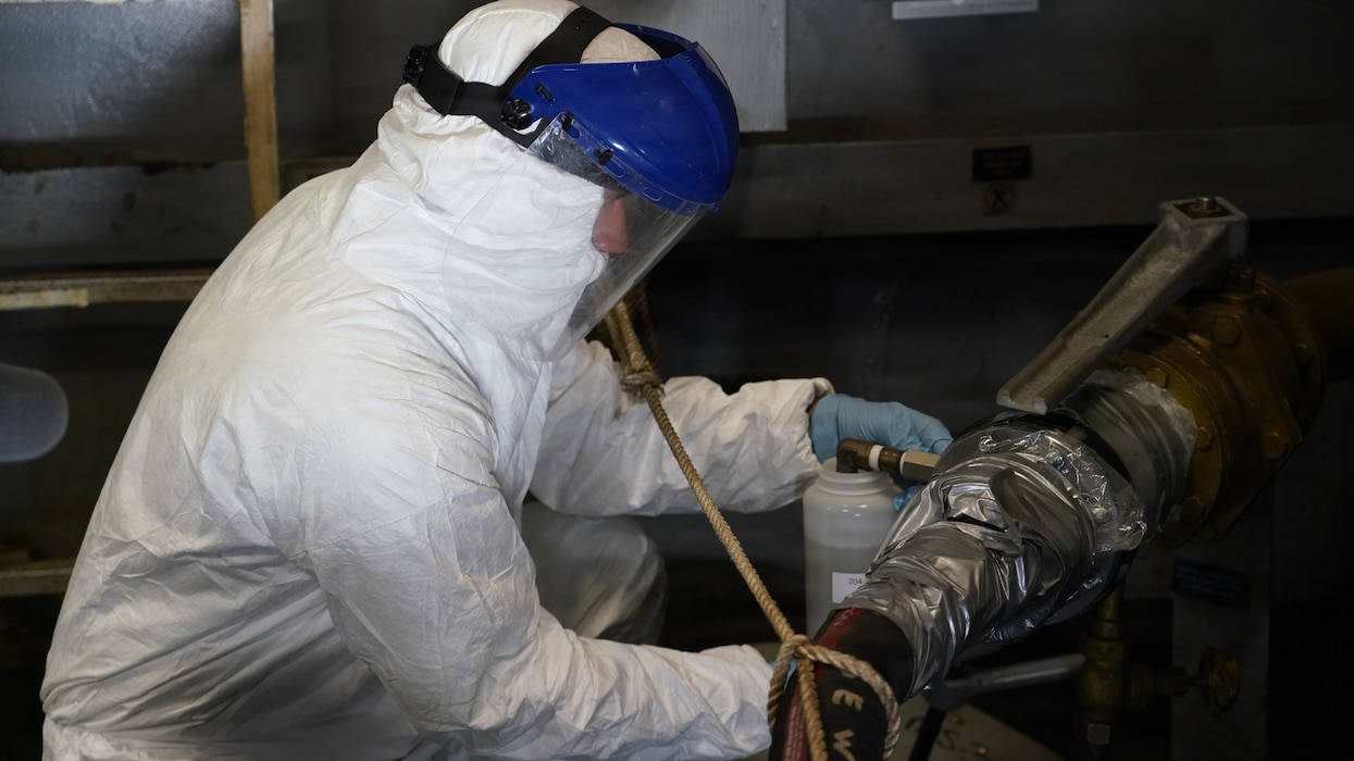 JOINT BASE PEARL HARBOR-HICKAM, Hawaii (June 26, 2026) Arturo Barrientos Montano of Naval Sea Systems Command retrieves a wastewater sample aboard Wasp-class amphibious assault ship USS Essex (LHD 2). This research study is in collaboration with Bureau of Medicine and Surgery, Naval Health Research Center, and Naval Surface Warfare Center during Rim of the Pacific (RIMPAC) exercise 2026. Thirty-one nations, 36 surface ships, 5 submarines, 15 national land forces, more than 206 aircraft and 25,000 personnel are participating in RIMPAC in and around the Hawaiian Islands, June 24 to July 31. The world's largest international maritime exercise, RIMPAC provides a unique training opportunity while fostering and sustaining cooperative relationships among participants critical to ensuring the safety of sea lanes and security on the world's oceans. RIMPAC 26 is the 30th exercise in the series that began in 1971. (U.S. Navy photo by Danielle Cazarez/Released)