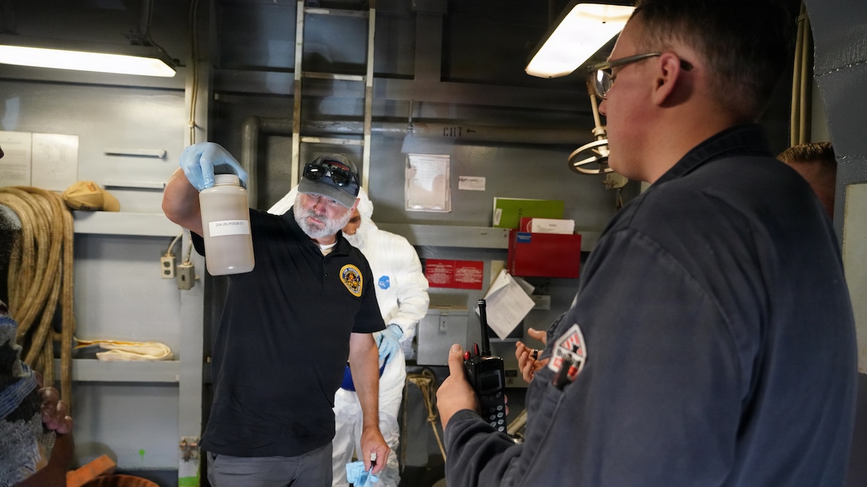 JOINT BASE PEARL HARBOR-HICKAM, Hawaii (June 26, 2026) John Garmon of Naval Surface Warfare Center demonstrates the first sample of wastewater aboard the USS Essex (LHD-2). Thirty-one nations, 36 surface ships, 5 submarines, 15 national land forces, more than 206 aircraft and 25,000 personnel are participating in RIMPAC in and around the Hawaiian Islands, June 24 to July 31. The world's largest international maritime exercise, RIMPAC provides a unique training opportunity while fostering and sustaining cooperative relationships among participants critical to ensuring the safety of sea lanes and security on the world's oceans. RIMPAC 26 is the 30th exercise in the series that began in 1971. (U.S. Navy photo by Danielle Cazarez/Released)