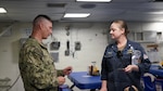 JOINT BASE PEARL HARBOR-HICKAM, Hawaii (June 26, 2026) Lt. Cmdr. Brian Williams of Naval Health Research Center (NHRC) discusses wearable devices capabilities with USS Essex (LHD-2) operations officer, Cmdr. Julia Kranz. Roughly 200 sailors aboard the Essex have been provided with an Oura Ring to track physiological data in order to inform illness prediction algorithms while participating in the Rim of the Pacific (RIMPAC) exercise. Thirty-one nations, 36 surface ships, 5 submarines, 15 national land forces, more than 206 aircraft and 25,000 personnel are participating in RIMPAC in and around the Hawaiian Islands, June 24 to July 31. The world's largest international maritime exercise, RIMPAC provides a unique training opportunity while fostering and sustaining cooperative relationships among participants critical to ensuring the safety of sea lanes and security on the world's oceans. RIMPAC 26 is the 30th exercise in the series that began in 1971. (U.S. Navy photo by Danielle Cazarez/Released)