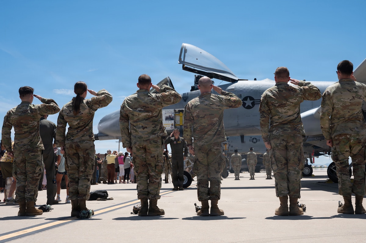 U.S. Air Force Airmen assigned to the 357th Fighter Generation Squadron salute Lt. Col. Ryan Rutter, 357th Fighter Squadron commander, as he exits an A-10C Thunderbolt II aircraft for the final time at Davis-Monthan Air Force Base, Arizona, July 29, 2026. The rendering of the final salute is a tradition reserved for the Squadron commander as they complete their final flight at an installation. (U.S. Air Force photo by Airman Najzee Kuzu)