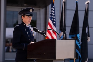 Change of command ceremony. People in uniform, & flags.