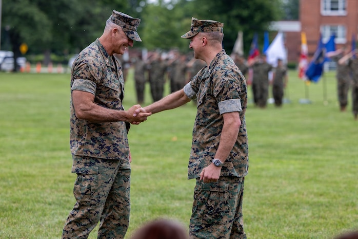 U.S. Marine Corps Col. Brian Blaine, left, the oncoming commanding officer of the 9th Marine Corps District, and Col. Aaron Lloyd, right, the outgoing commanding officer of the district, shake hands during a change of command ceremony at Naval Station Great Lakes in Great Lakes, Ill., July 31, 2026. The change of command ceremony served as the official changeover between commanding officers, honoring the outgoing officer’s contributions to the unit while offering the opportunity for the oncoming officer to introduce himself to the Marines now under his charge. (U.S. Marine Corps photo by Cpl. Maxwell Cook)