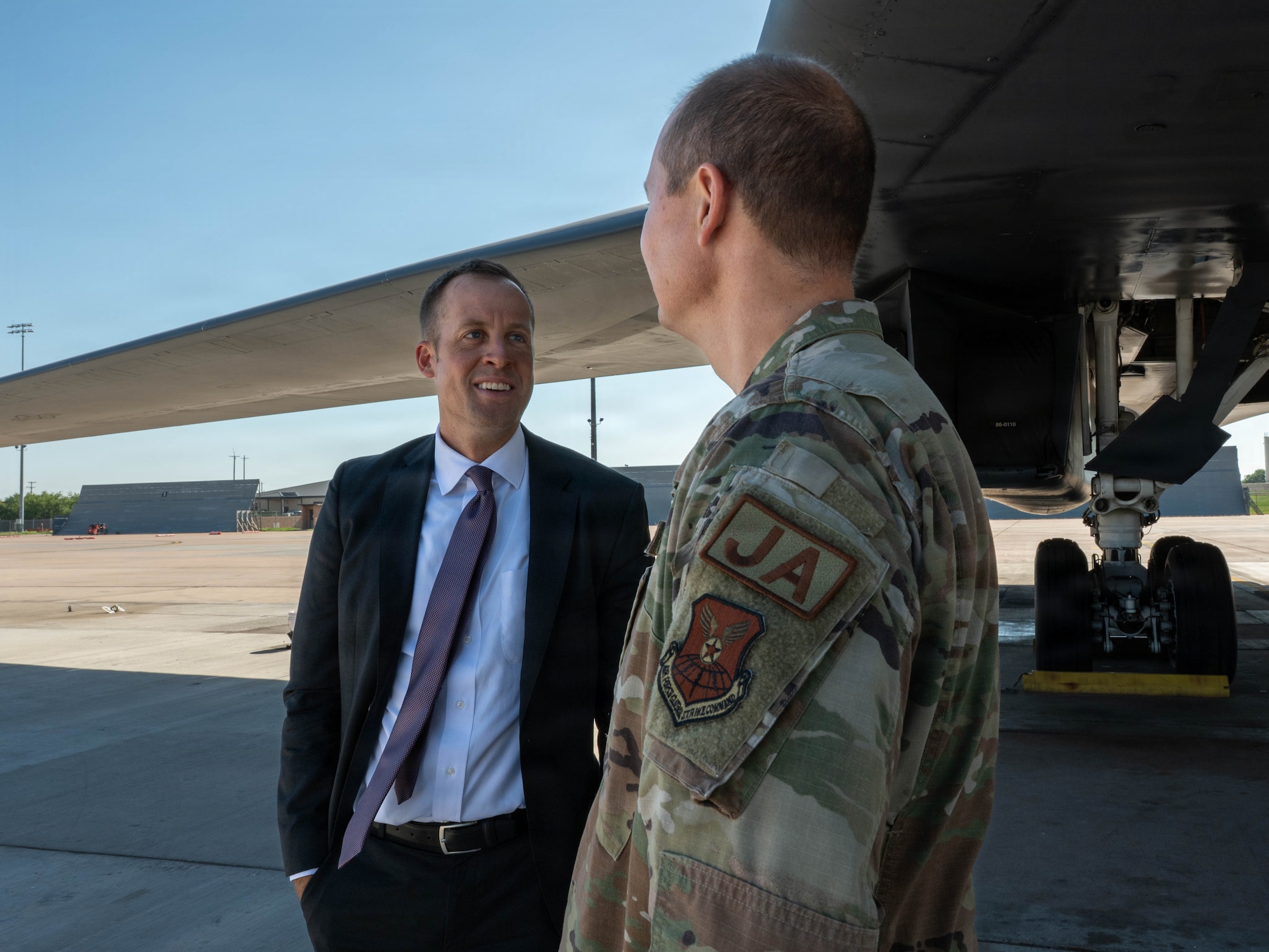 People talk outside on the flightline.