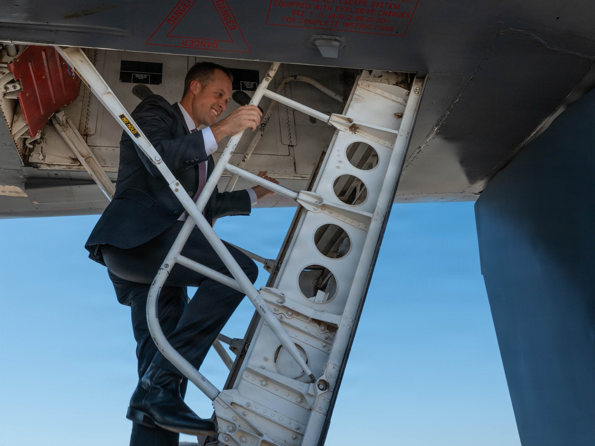 Civilian climbs ladder into B-1.