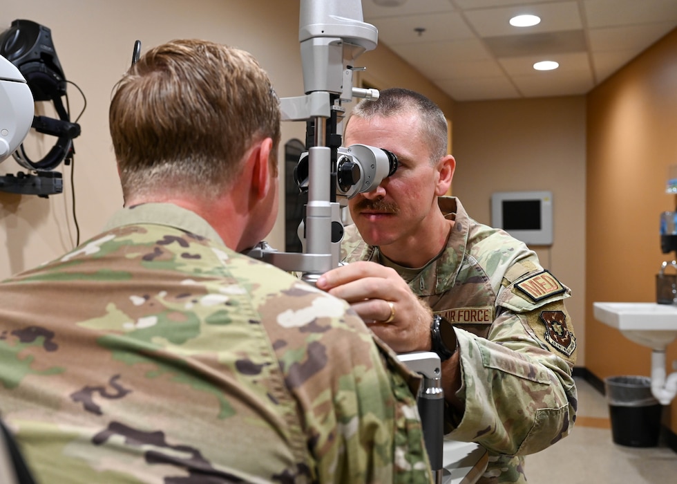 U.S. Air Force Capt. Max Sarver, right, Luke Medical Group Operational Medical Readiness Squadron optometry element chief, performs an eye exam at Luke Air Force Base, Arizona, July 29, 2026. Air Force healthcare professionals receive medical and readiness training to effectively and efficiently respond to both mission requirements and real-world lifesaving scenarios.