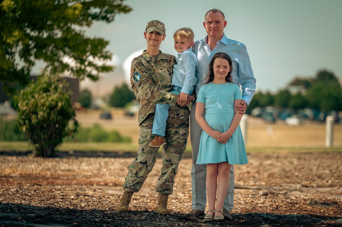 a family of four poses for a group photo