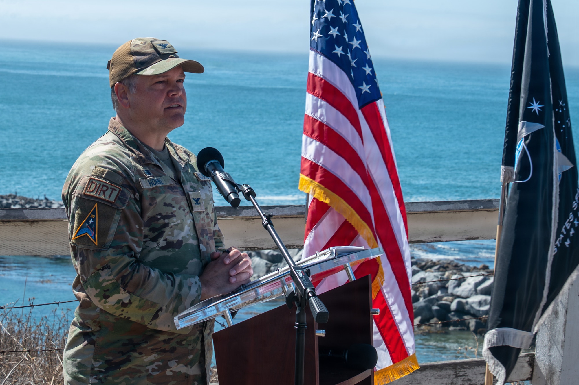 A person stands behind a podium and speaks