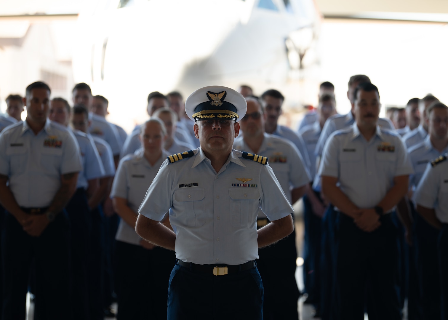 U.S. Coast Guard Cdr. Jason Carrillo, an engineering officer attached to Coast Guard Air Station Sacramento, stands at parade rest during a change of command ceremony at Air Station Sacramento, McClellan Park, California, July 31, 2026. During the ceremony, Coast Guard Capt. Patrick Dill was formally recognized as the new air station commander. (U.S. Coast Guard photo by Petty Officer 3rd Class Kenneth Wiese)