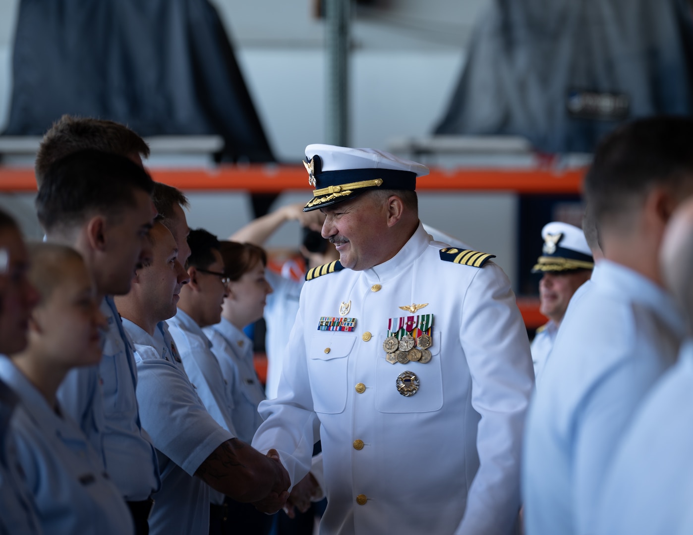 U.S. Coast Guard Capt. Bradford Apitz shakes hands during a unit inspection at Air Station Sacramento, McClellan Park, California, July 31, 2026. Following the inspection, Coast Guard Capt. Patrick Dill was formally recognized as the new air station commander during a change of command ceremony. (U.S. Coast Guard photo by Petty Officer 3rd Class Kenneth Wiese)