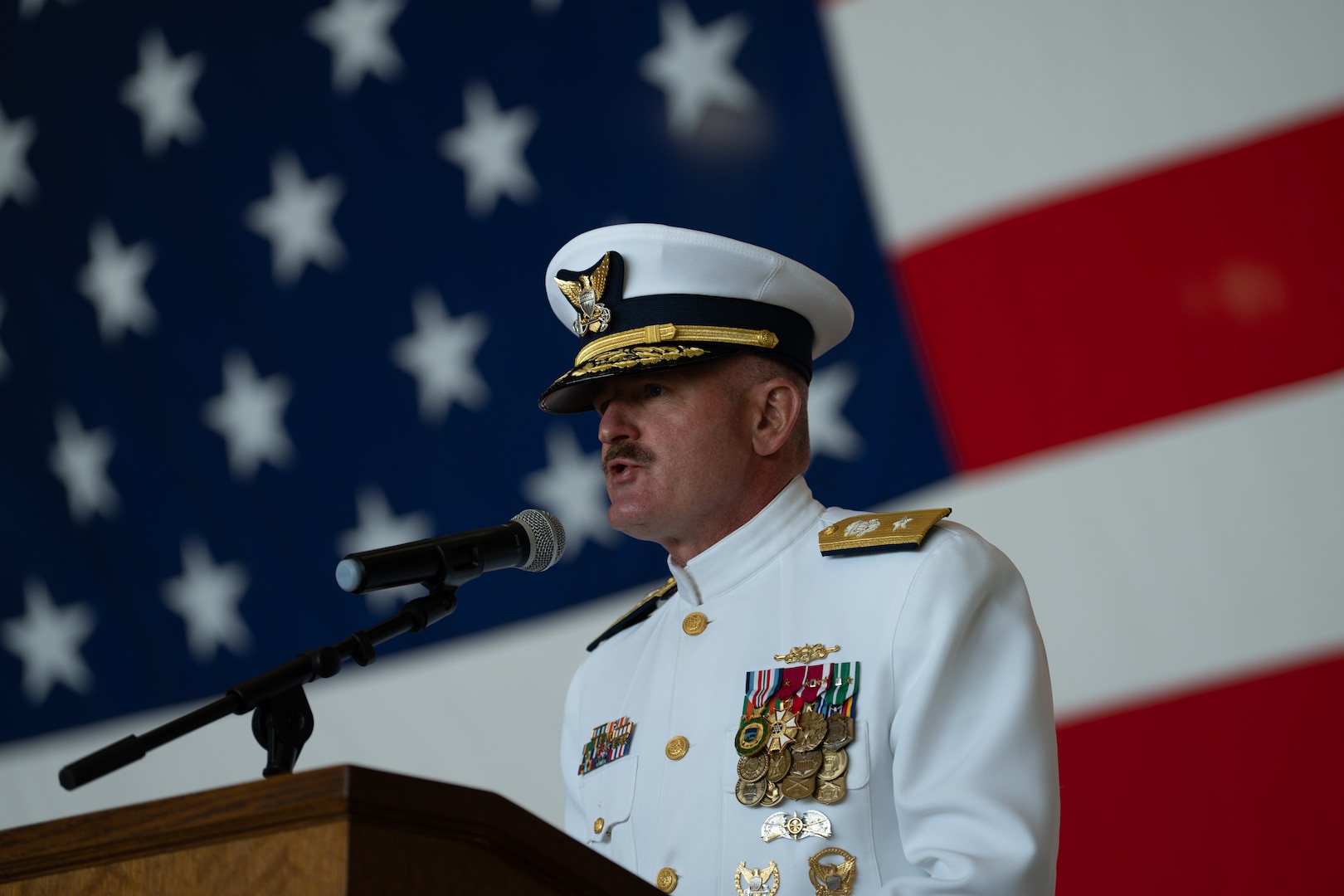 U.S. Coast Guard Rear Adm. Jeffery Novak, the Coast Guard Southwest District commander, addresses audience members during a change of command ceremony at Air Station Sacramento, McClellan Park, California, July 31, 2026. During the ceremony, Coast Guard Capt. Patrick Dill was formally recognized as the new air station commander. (U.S. Coast Guard photo by Petty Officer 3rd Class Kenneth Wiese)