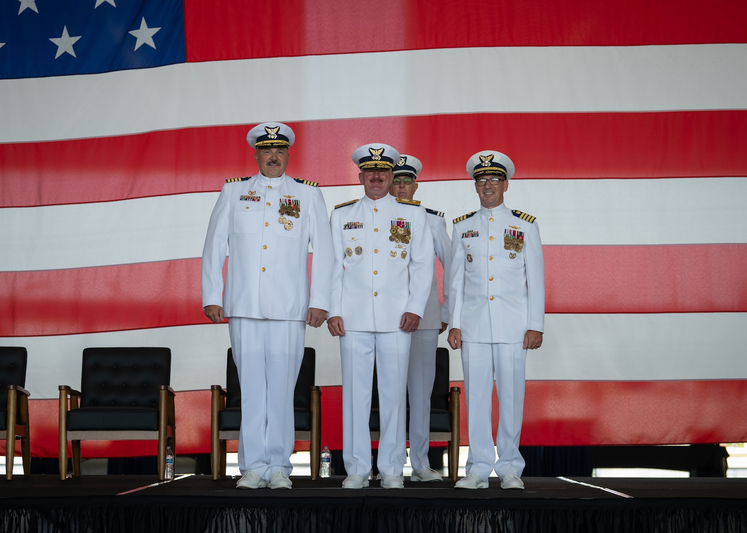 U.S. Coast Guard Capt. Bradford Apitz, Rear Adm. Jeffery Novak, the Coast Guard Southwest District commander, and Capt. Patrick Dill, the Coast Guard Air Station Sacramento commander, pose during a change of command ceremony at Air Station Sacramento, McClellan Park, California, July 31, 2026. During the ceremony Dill was formally recognized as the new air station commander. (U.S. Coast Guard photo by Petty Officer 3rd Class Kenneth Wiese)