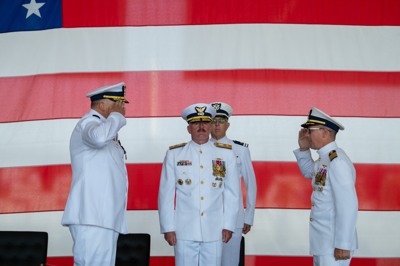 U.S. Coast Guard Capt. Bradford Apitz and Capt. Patrick Dill render a salute during a change of command ceremony at Air Station Sacramento, McClellan Park, California, July 31, 2026. During the ceremony, Dill was formally recognized as the new air station commander. (U.S. Coast Guard photo by Petty Officer 3rd Class Kenneth Wiese)