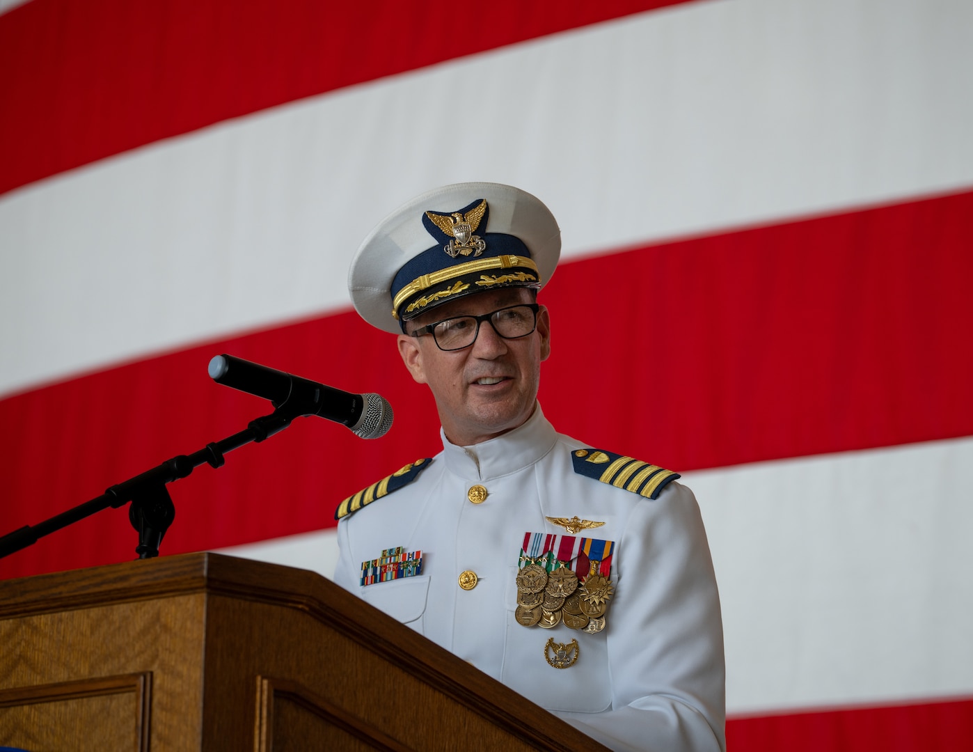U.S. Coast Guard Capt. Captain Patrick Dill addresses an audience at Air Station Sacramento, McClellan Park, California, July 31, 2026. Dill was formally recognized as the new air station commander during a change of command ceremony. (U.S. Coast Guard photo by Petty Officer 3rd Class Kenneth Wiese)