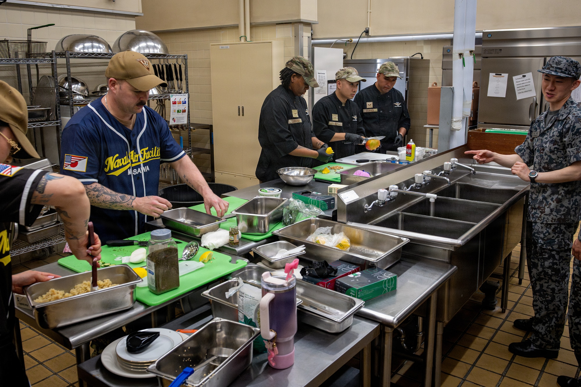 U.S. Air Force, Navy, and Japan Air Self-Defense Force culinary specialists prepare food for a competition.