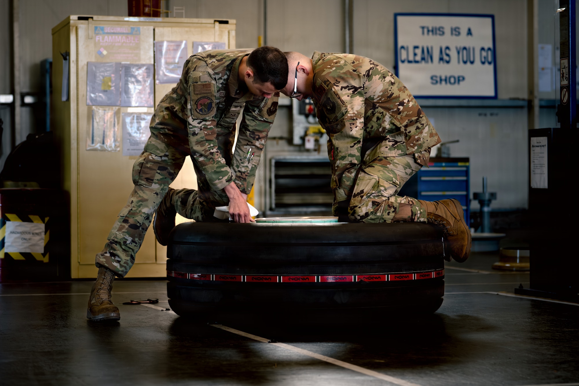 U.S. Air Force Senior Airman Andrew Bolek, 86th Maintenance Squadron wheel and tire journeyman, left, and Staff Sgt. Josiah Nave, 86th MXS repair and reclamation journeyman, lift the rim off a C-130J Super Hercules aircraft tire at Ramstein Air Base, Germany, May 29, 2026.